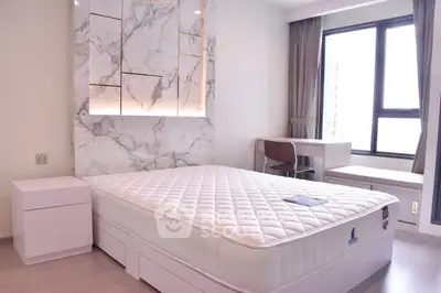 Modern bedroom with stylish marble accent wall and large window