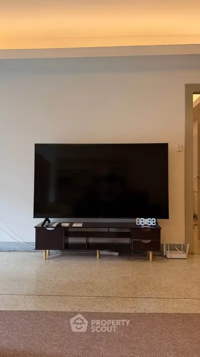 Modern living room with sleek TV setup and stylish furniture