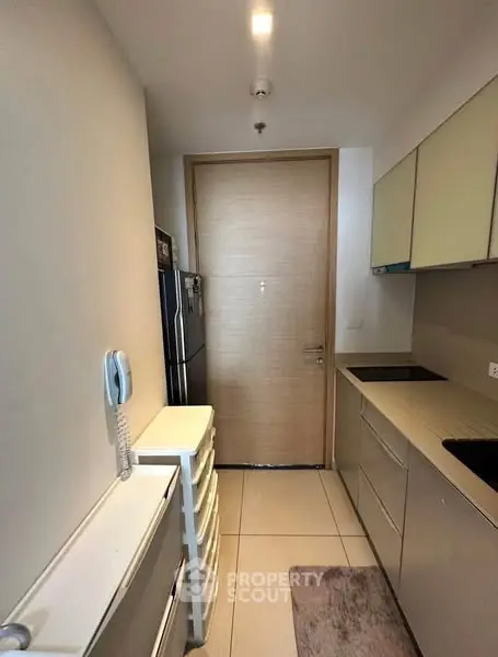 Modern compact kitchen with sleek cabinets and built-in appliances