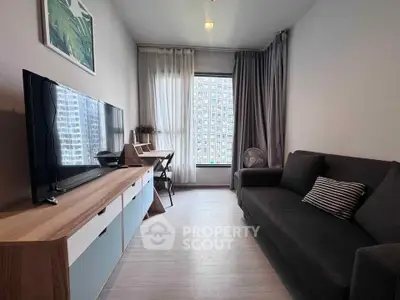 Modern living room with sleek furniture and city view from large window.