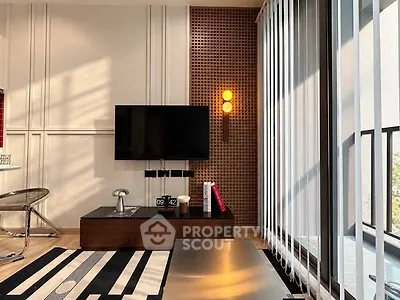 Modern living room with stylish decor and large windows offering natural light.