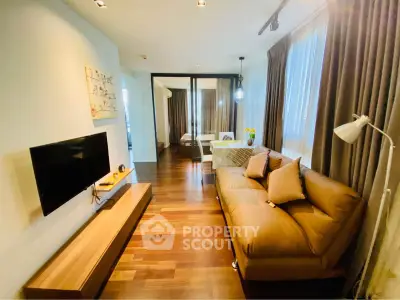 Modern living room with cozy sofa and wall-mounted TV in stylish apartment