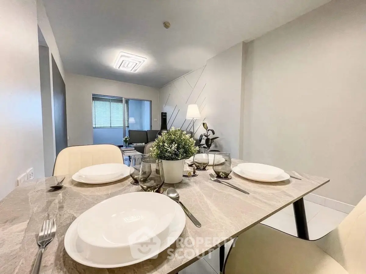 Modern dining area with elegant table setting in a stylish open-plan living room.
