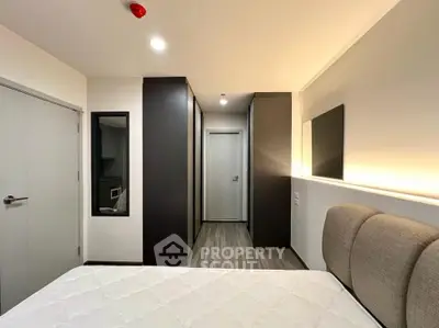 Modern bedroom with sleek design and ambient lighting, featuring a comfortable bed and stylish wardrobe.