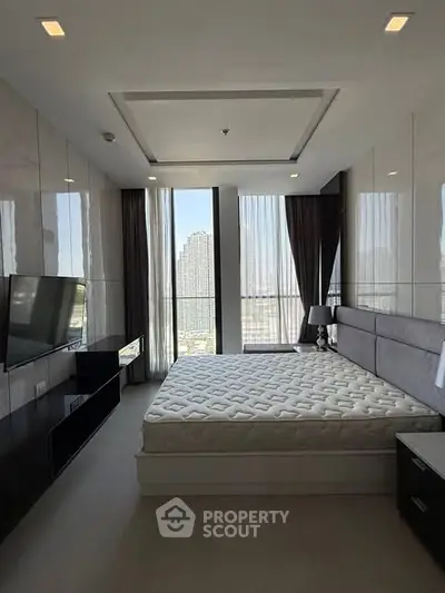 Luxurious bedroom with modern decor and stunning city view, featuring a large bed and sleek furnishings.