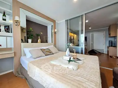Modern bedroom with stylish decor and sliding glass doors in a cozy apartment.