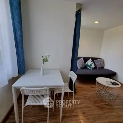 Charming living area with cozy seating and dining space, perfect for modern living.