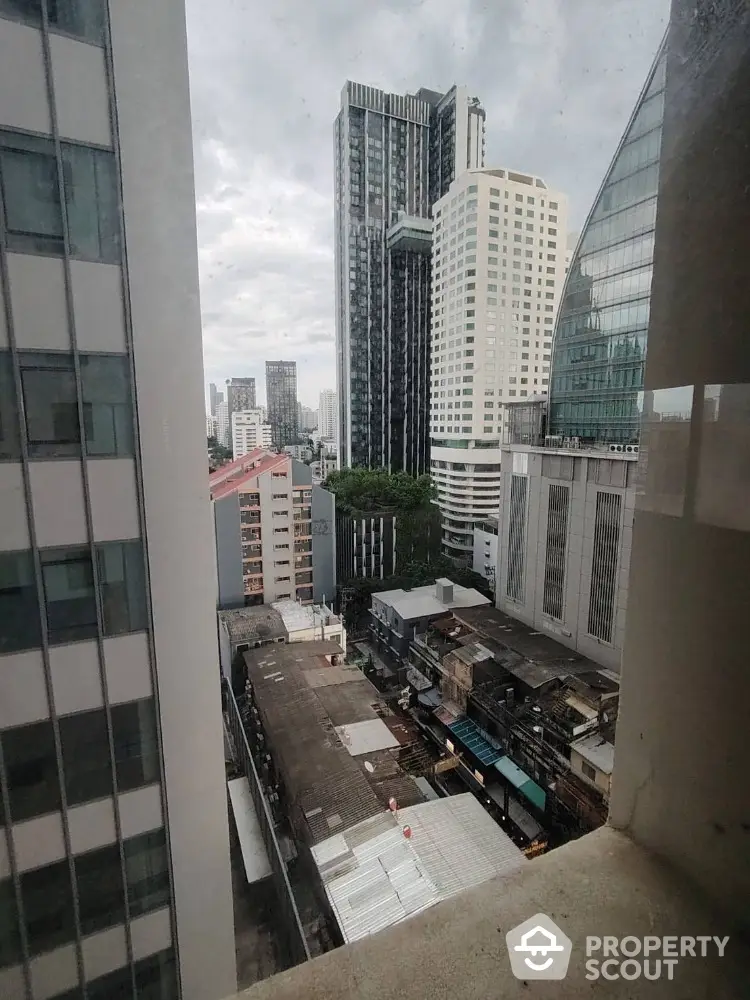 Stunning cityscape view from high-rise building window showcasing modern urban architecture.