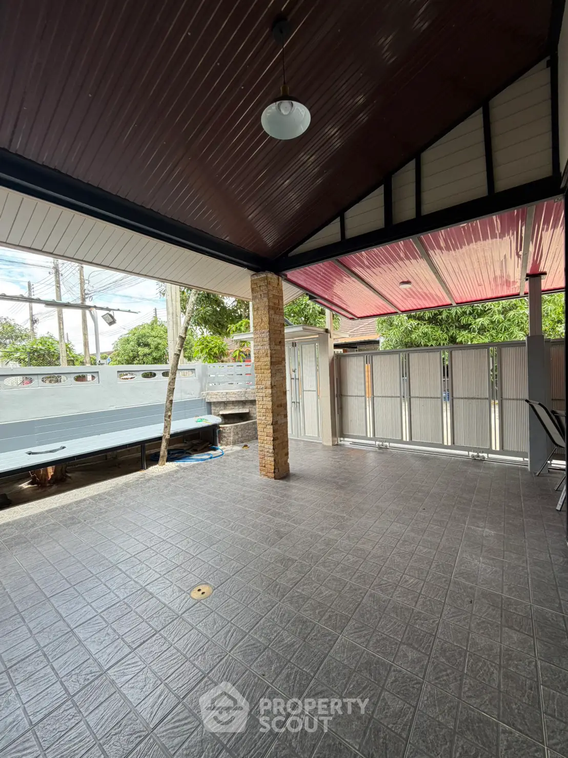 Spacious covered outdoor area with tiled flooring and modern design