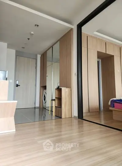 Modern apartment interior with wooden flooring and built-in storage