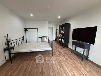 Spacious bedroom with modern furnishings and wooden flooring