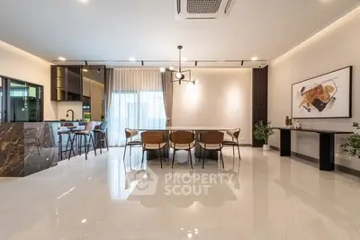 Spacious modern dining area with elegant marble accents and stylish lighting.