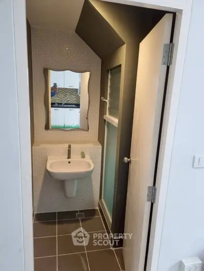 Compact modern bathroom with stylish mirror and sleek fixtures