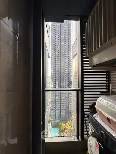 Urban high-rise view from a narrow balcony with modern design elements.