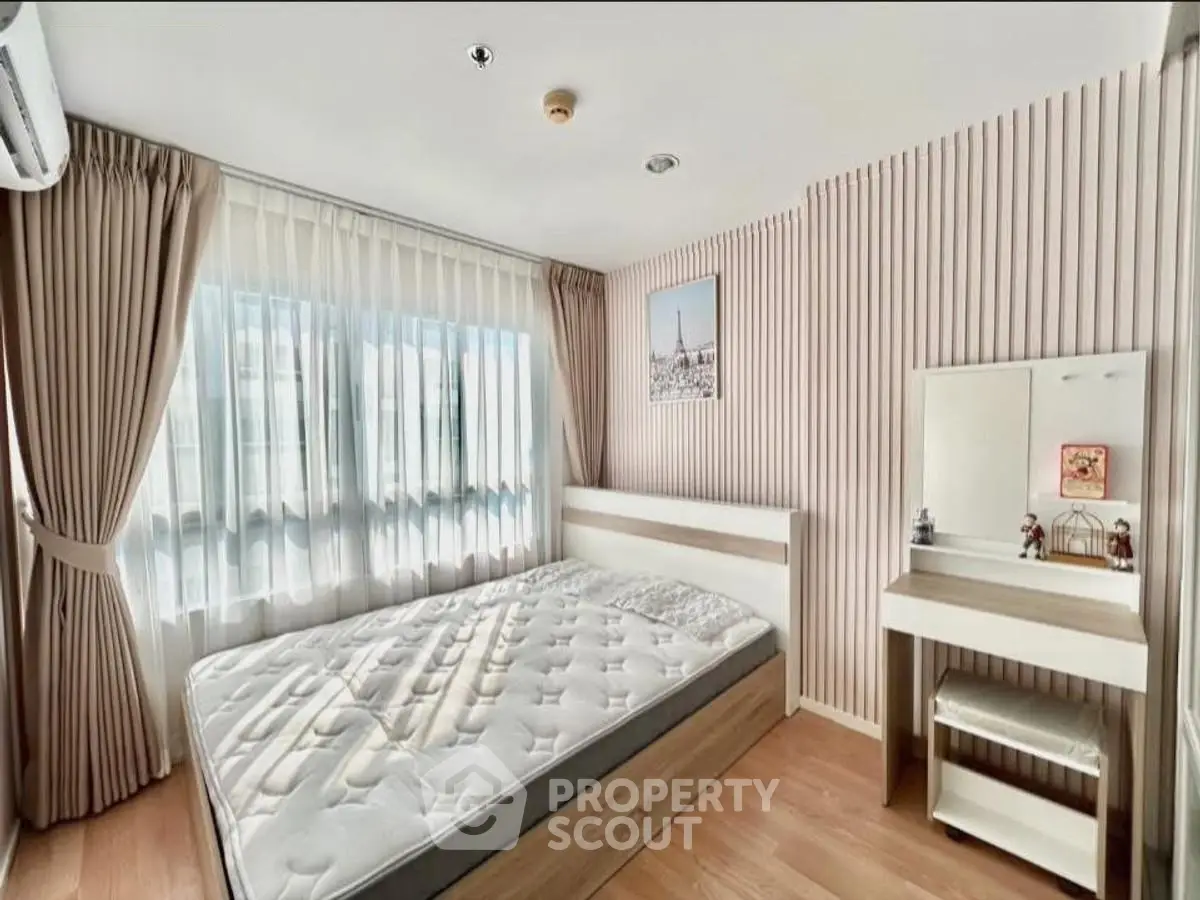 Bright and airy bedroom with large window and stylish decor