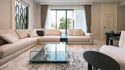 Luxurious modern living room with elegant furniture and large windows