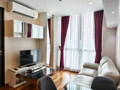 Modern living room with sleek furniture and large windows in a stylish apartment.