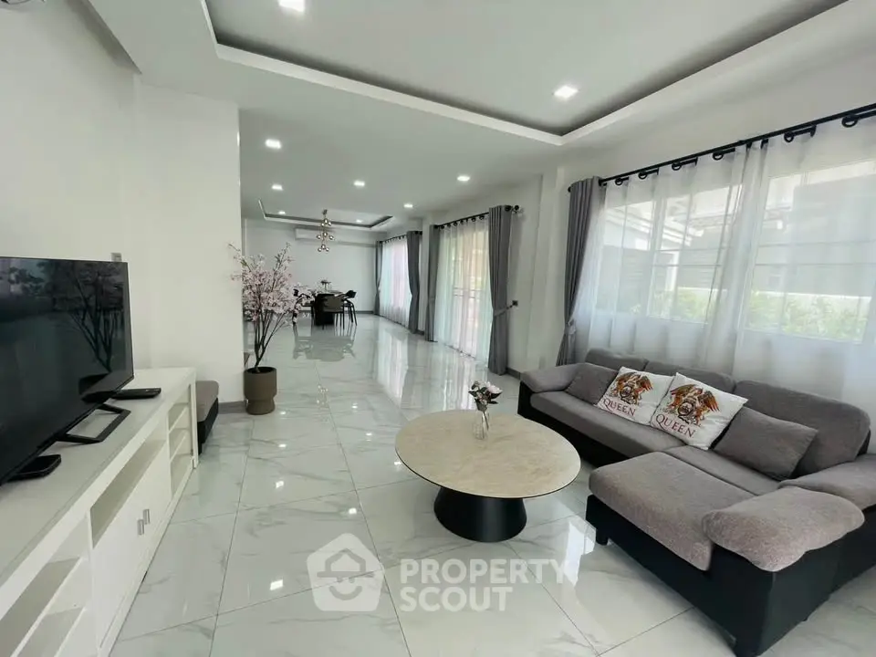 Spacious modern living room with elegant decor and large windows