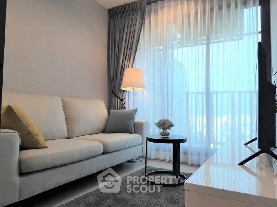 Modern living room with cozy sofa, elegant curtains, and ambient lighting.