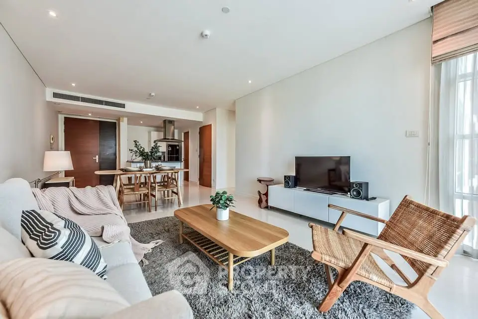 Spacious modern living room with stylish furniture and open kitchen layout