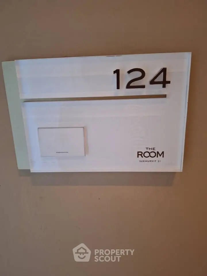 Modern room number sign with sleek design at The Room Sukhumvit 21.