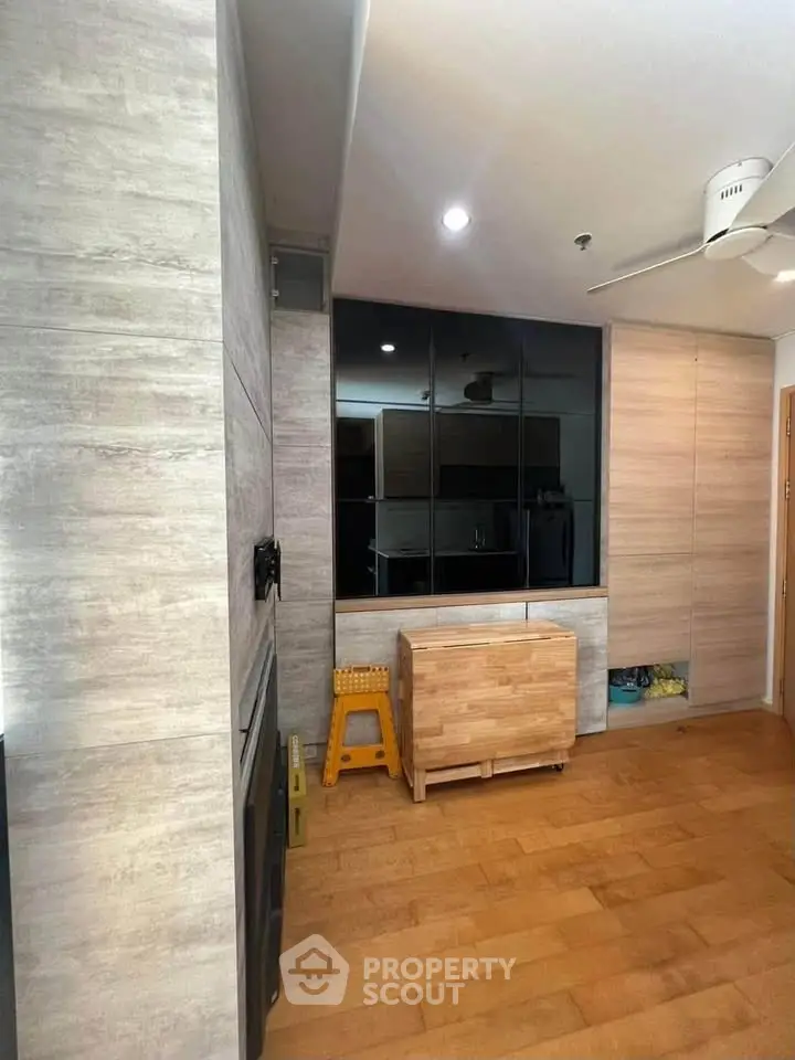Modern living room with wooden flooring and sleek storage solutions
