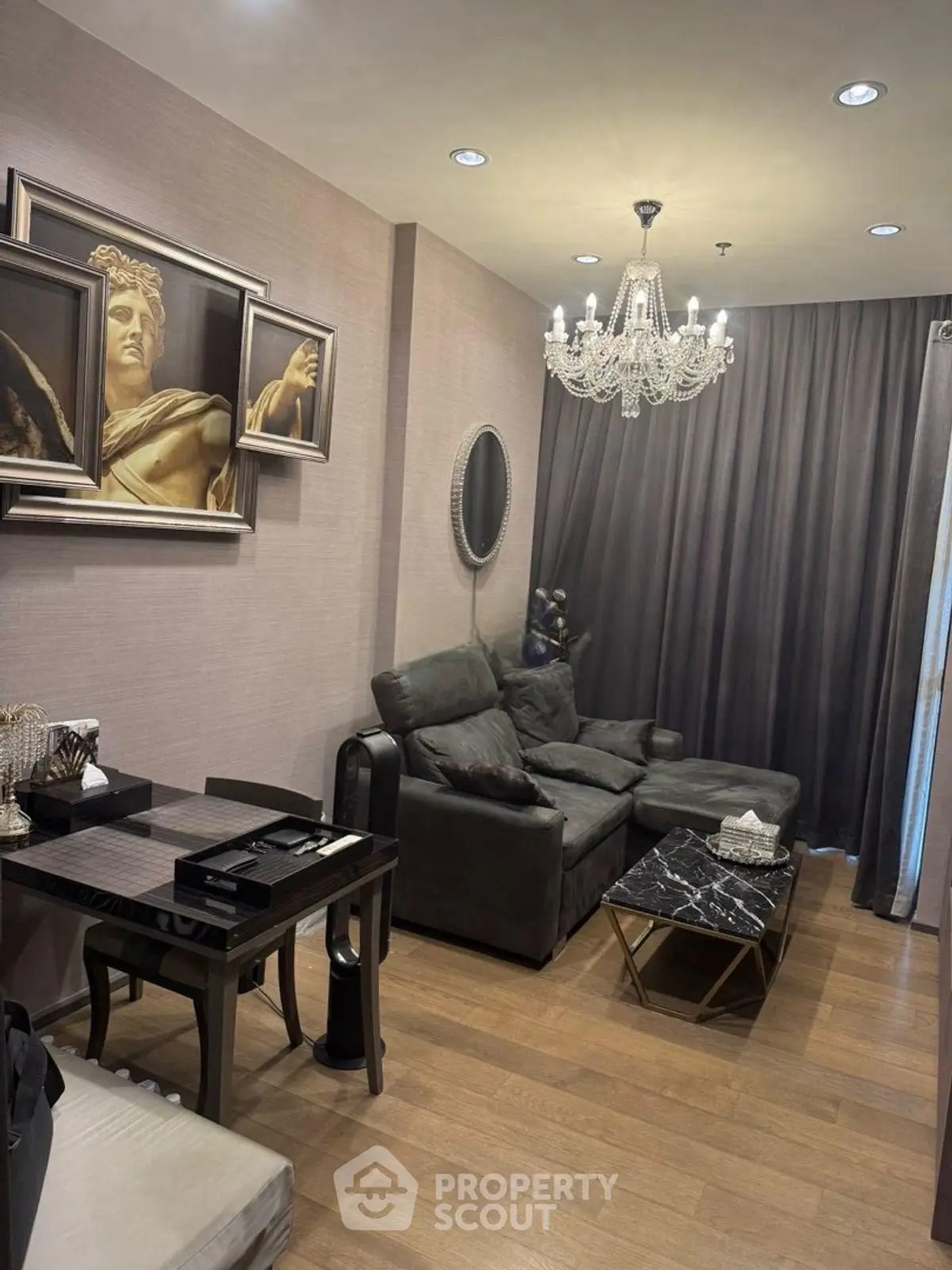 Luxurious living room with elegant chandelier and modern art decor