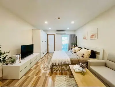 Spacious modern bedroom with stylish decor and natural light