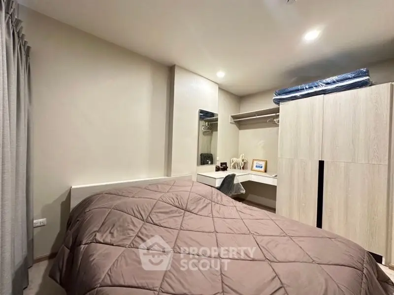 Cozy bedroom with modern furnishings and ample closet space