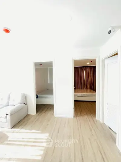 Bright modern apartment interior with wooden flooring and cozy furnishings.