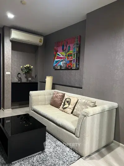 Modern living room with stylish sofa, vibrant artwork, and sleek air conditioning unit.