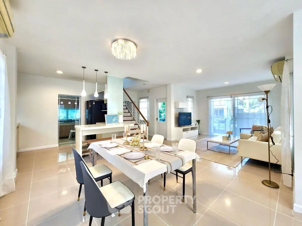 Spacious open-plan living and dining area with modern decor and natural light.