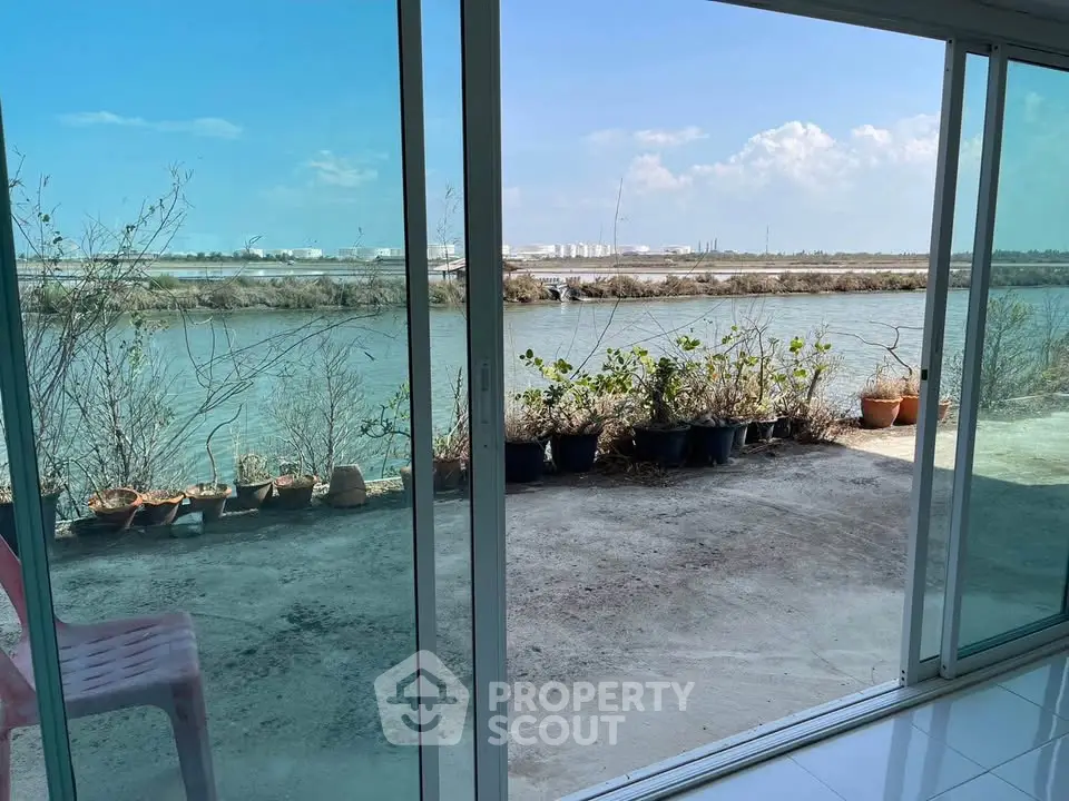 Stunning waterfront view from modern glass doors in serene setting