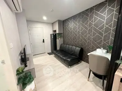 Modern living room with stylish geometric accent wall and sleek black sofa