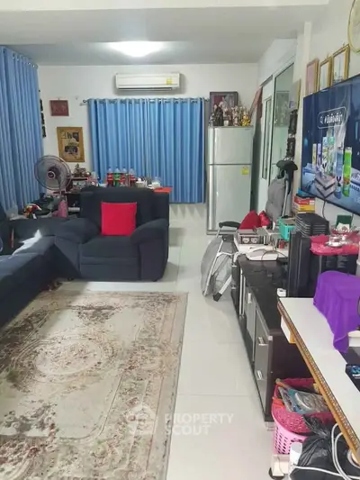 Spacious living room with modern decor and large windows for natural light.
