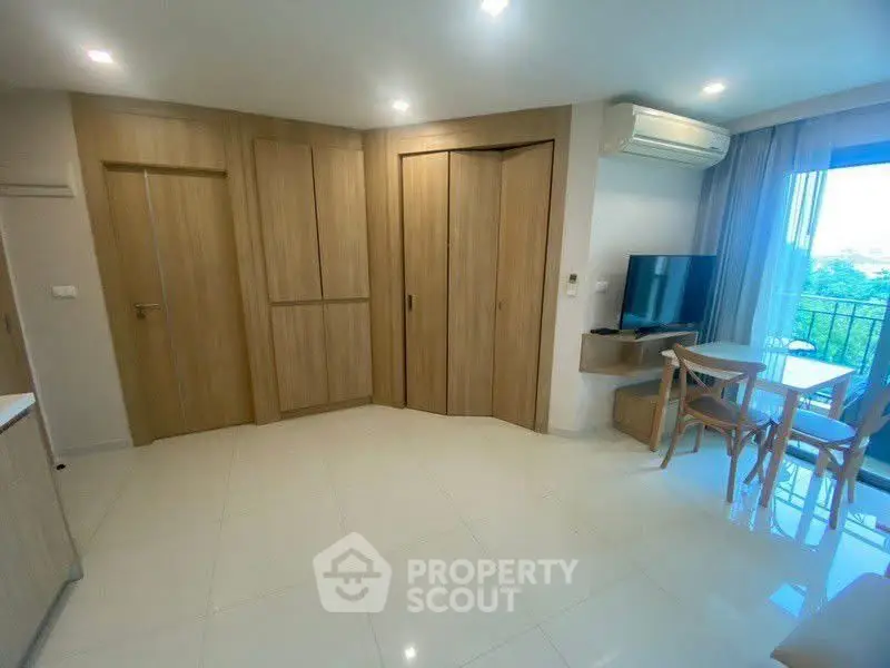 Modern living room with wooden accents and balcony view