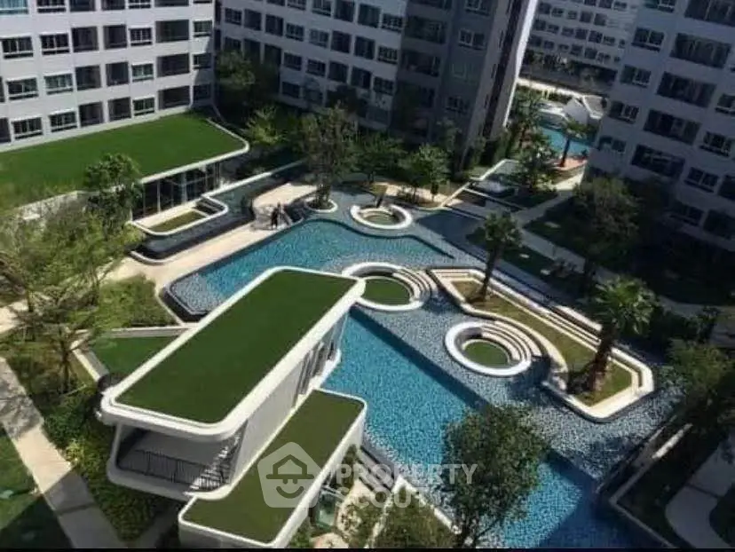 Luxurious modern apartment complex with stunning rooftop garden and pool area.
