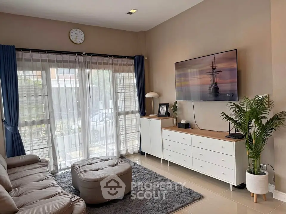 Cozy living room with modern decor, large window, and stylish furniture.