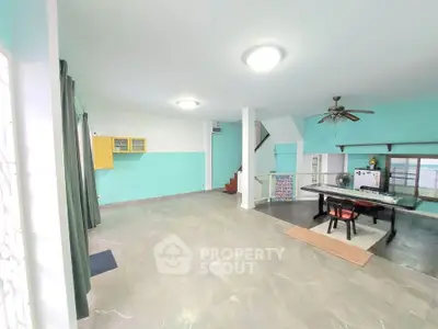 Spacious open-plan living room with modern decor and ample natural light.