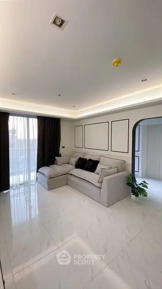 Spacious modern living room with elegant decor and large windows