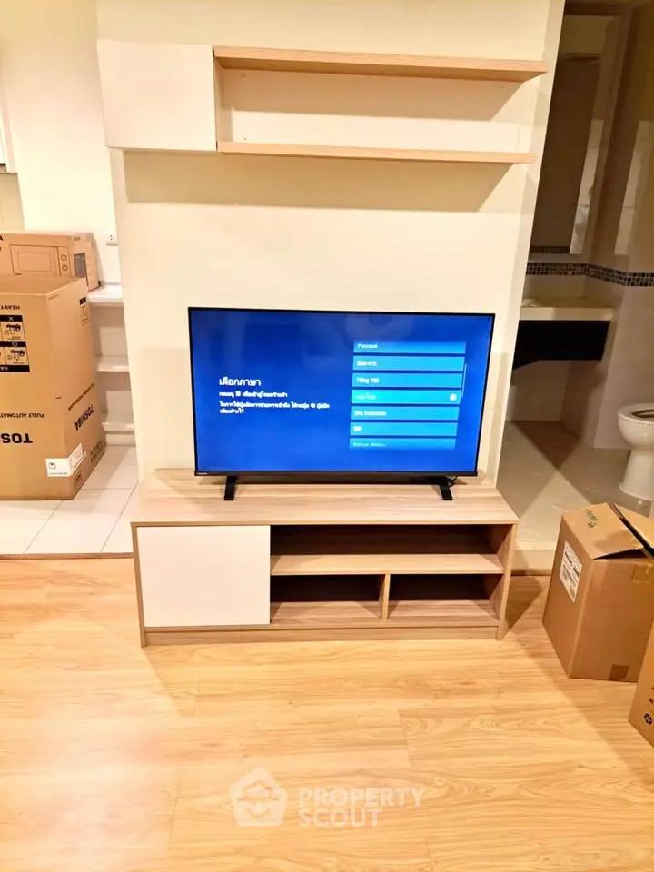 Modern living room with TV stand and wooden flooring, ideal for cozy entertainment setup.
