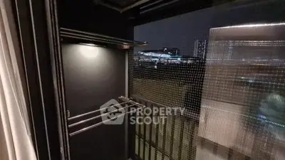 Modern balcony with night city view and sleek railing design.