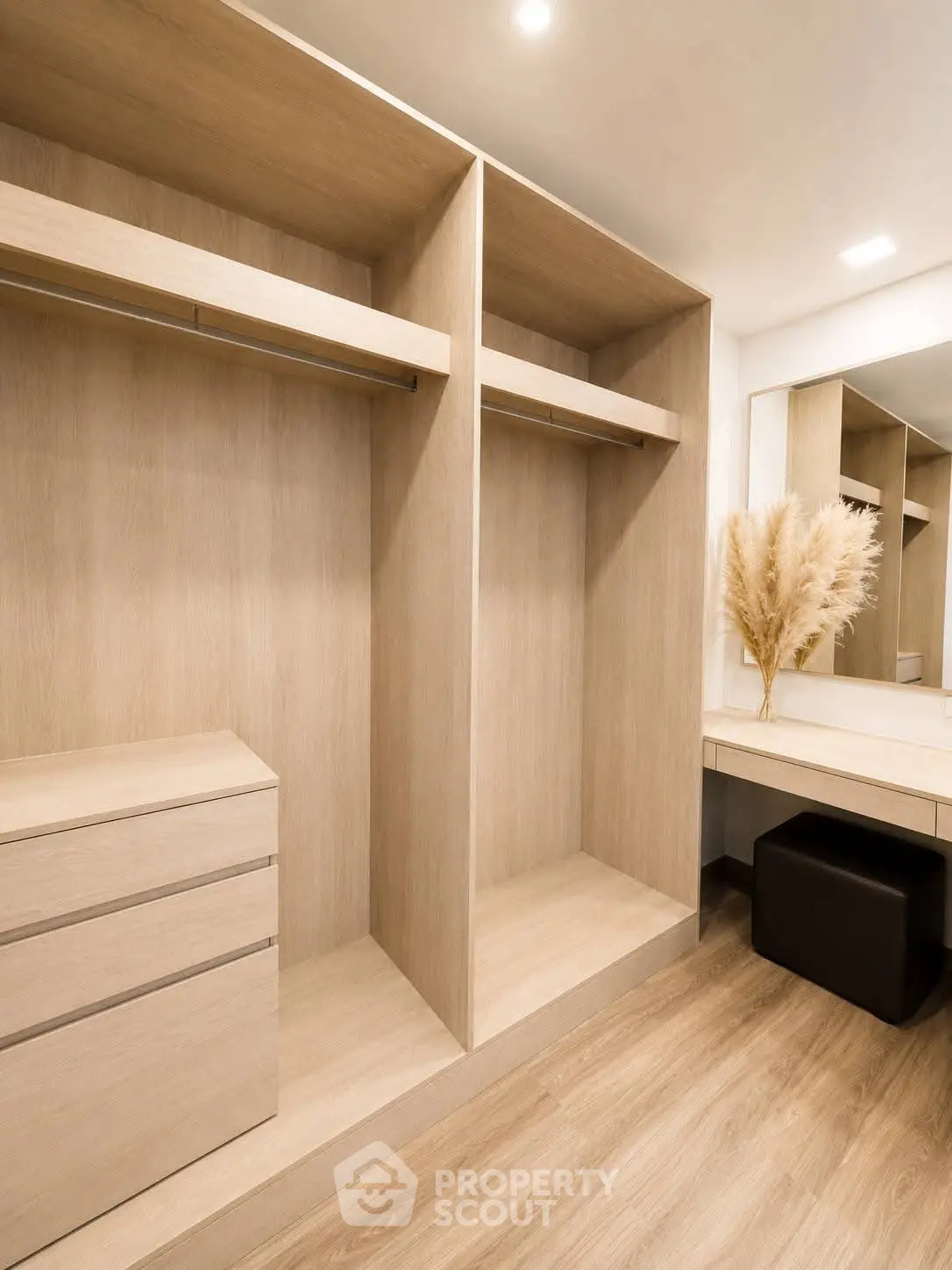 Spacious walk-in closet with modern wooden finish and ample storage space.