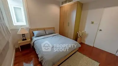 Cozy bedroom with wooden flooring and modern decor