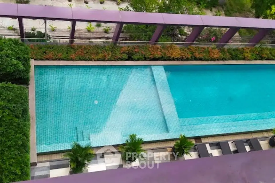 Luxurious rooftop pool with lush greenery and modern design, perfect for relaxation and leisure.