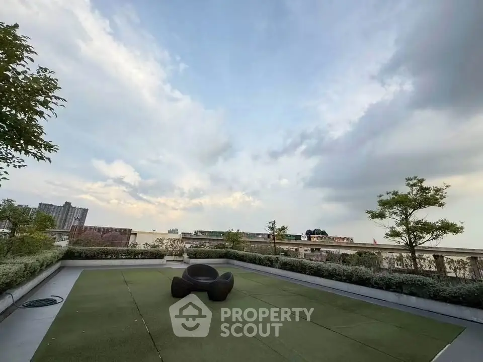 Stunning rooftop garden with modern seating and panoramic city views, perfect for relaxation and entertainment.