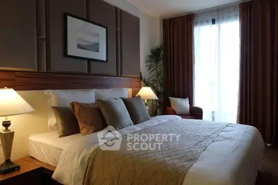 Luxurious bedroom with elegant decor and natural light, perfect for relaxation.
