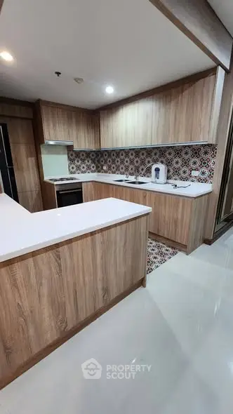 Modern kitchen with stylish wooden cabinets and patterned backsplash