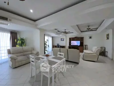 Spacious living room with elegant ceiling design and comfortable seating