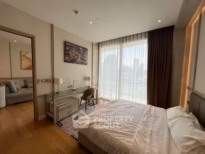 Luxurious bedroom with stunning city view, elegant decor, and natural light